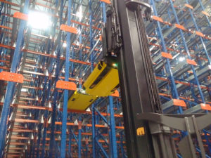 Frazier's Pallet Mole® shuttle is lifted into place by a fork truck.