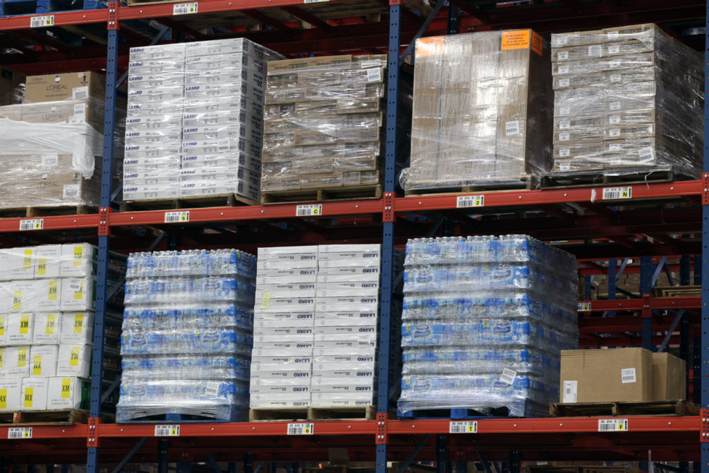 Bays of Frazier's Sentinel® Selective Pallet Rack with Label Beams® stores pallets of products.