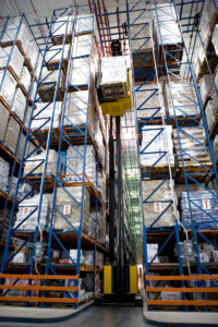 A swing reach truck picks product from Frazier's Sentinel Selective Pallet Rack in a refrigerated warehouse.