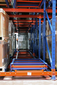 Unloaded Glide-In® Push Back rack carts envelope at the face position.
