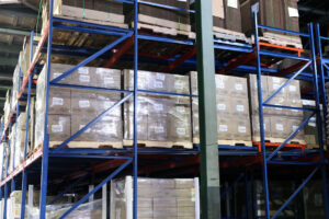 A side view of Glide-In® Push Back rack shows pallets stored 4 positions deep.