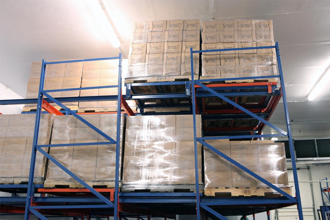 A side view of four pallet position deep Glide-In® Push Back rack.