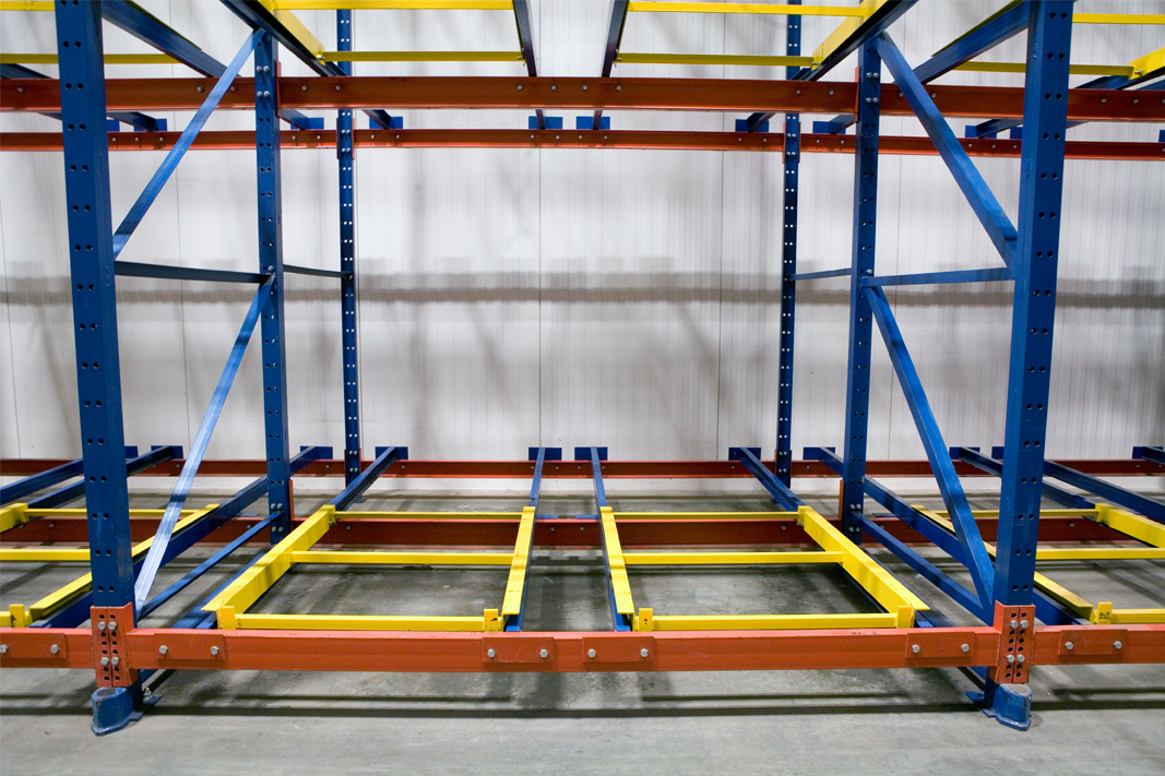 An unloaded bay of two pallet position deep Glide-In® Push Back rack.