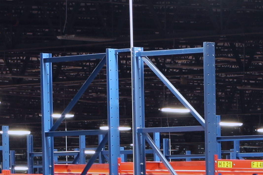 A Back-to-Back Tie connects two pallet rack frames.